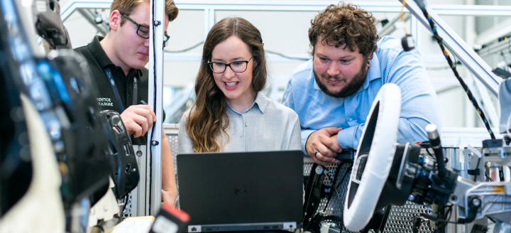 A class of students works with a computer in an engineering lab