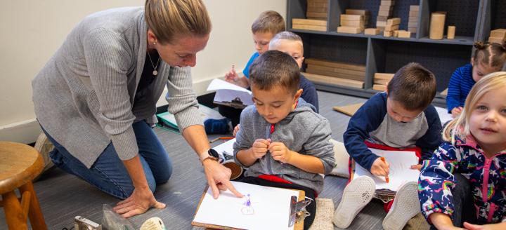 A teacher works with a class of young children