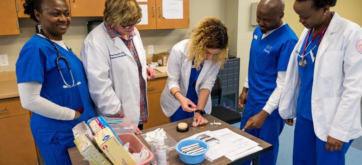 Nursing students gather to learn about medical instruments