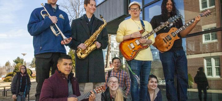 Music students pose with their instruments in from the QuEST building