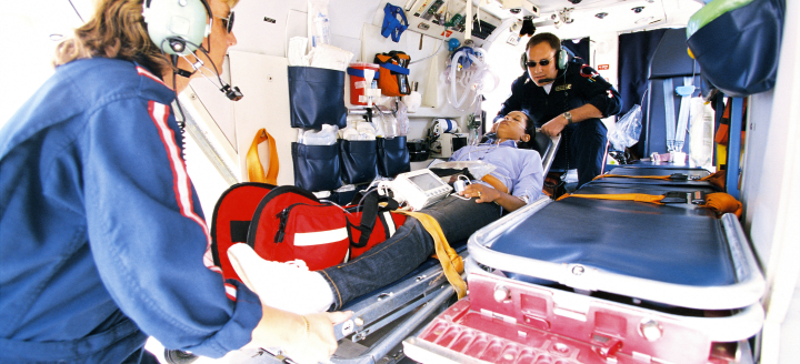 EMTs pull a patient into the ambulance