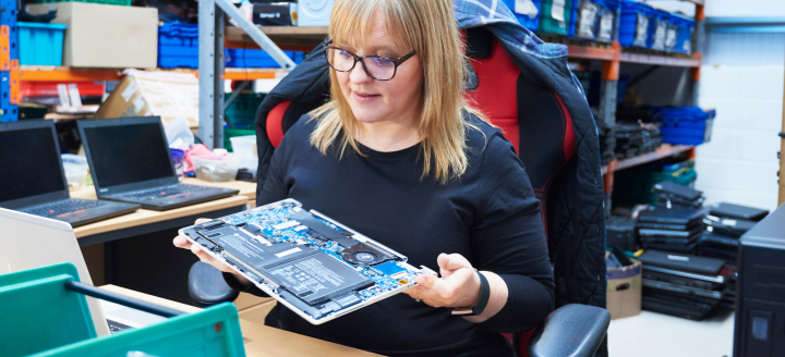 A woman holds a circuitboard