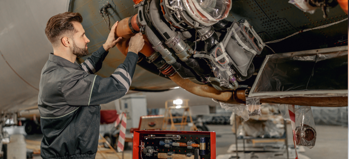 A man works to fix an airplane