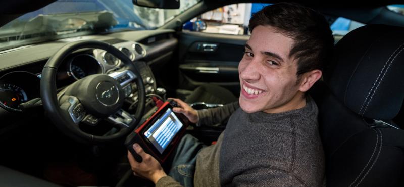 A student runs tests inside an automobile