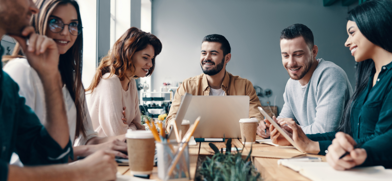 A group of business professionals sit at a table and chat