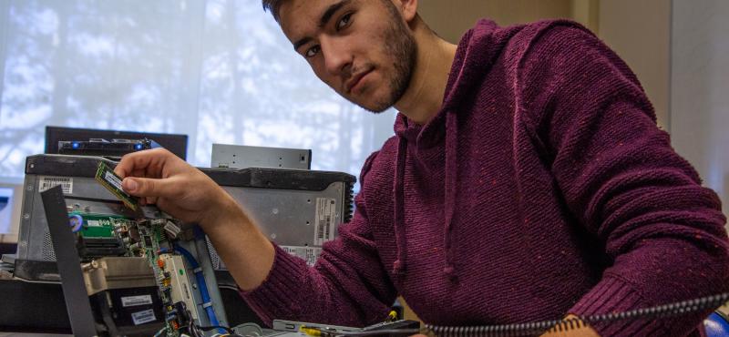 A student places components in a hand-built computer