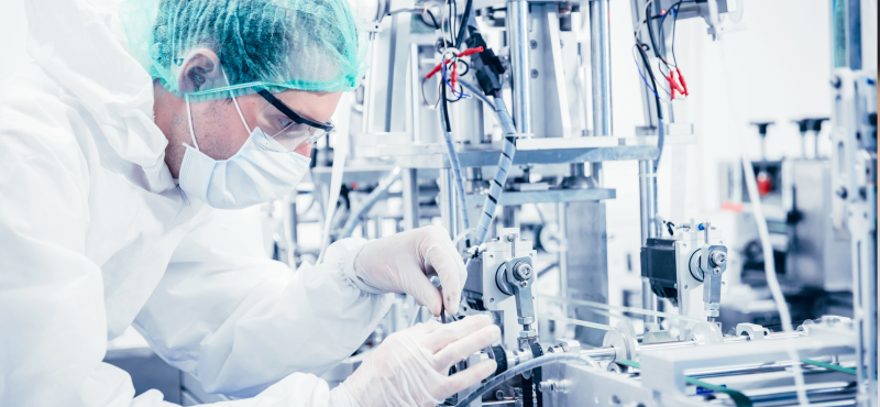 A man configures medical machinery in a lab