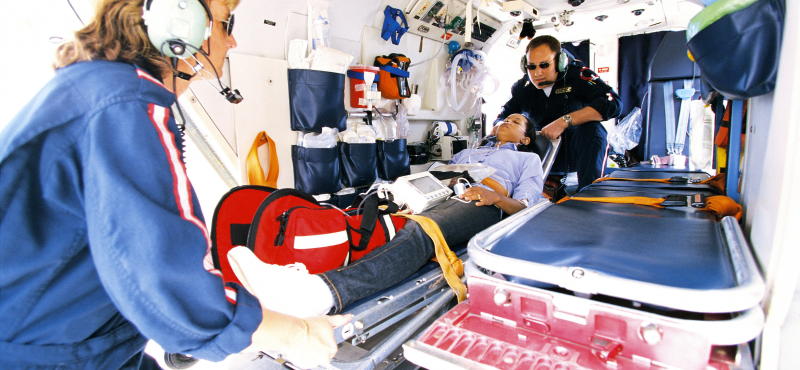 EMTs pull a patient into the ambulance