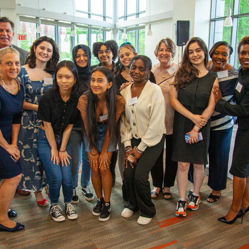 A group of high school students, including Liana, pose with the directors of QCC’s Early College program