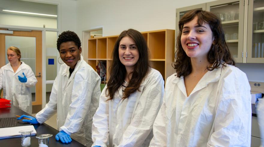 Pharmacy Tech students work at a desk in a lab